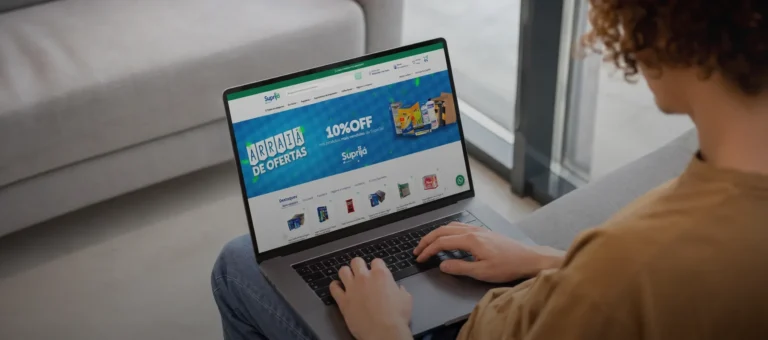 Pessoa usando notebook em casa, acessando o site da Suprijá em busca de ofertas.
